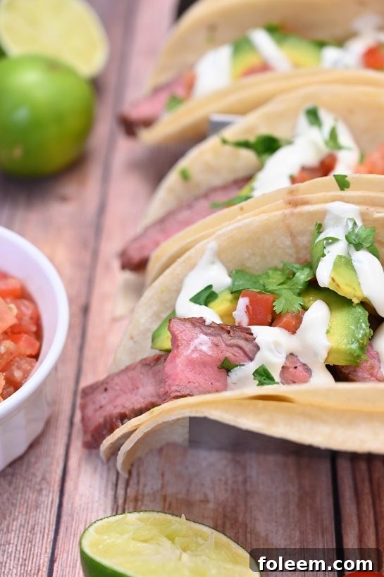 Tender, juicy Grilled Flank Steak Tacos with avocado and cilantro lime crema, ideal for weeknights or summer weekends.