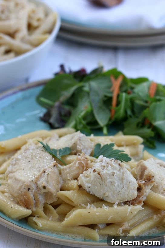 Chicken Alfredo served over penne pasta.