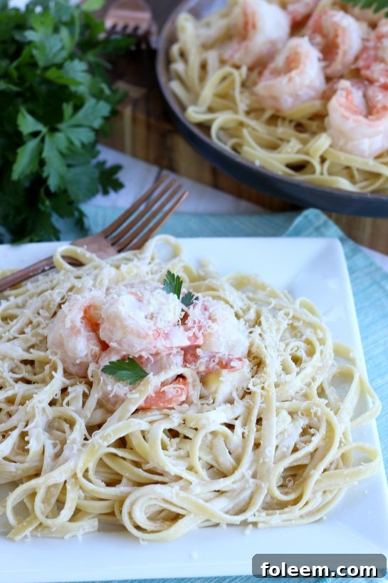 Another look at the shrimp with garlic sauce and pasta on a plate ready to serve. Garlic butter shrimp are almost too pretty to eat!