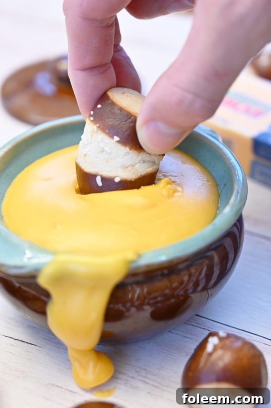 Sharp Cheddar Hard Cider Fondue recipe perfect for game day, party appetizers or intimate dinners. Choose your favorite selection of dippers and see how delicious this is!