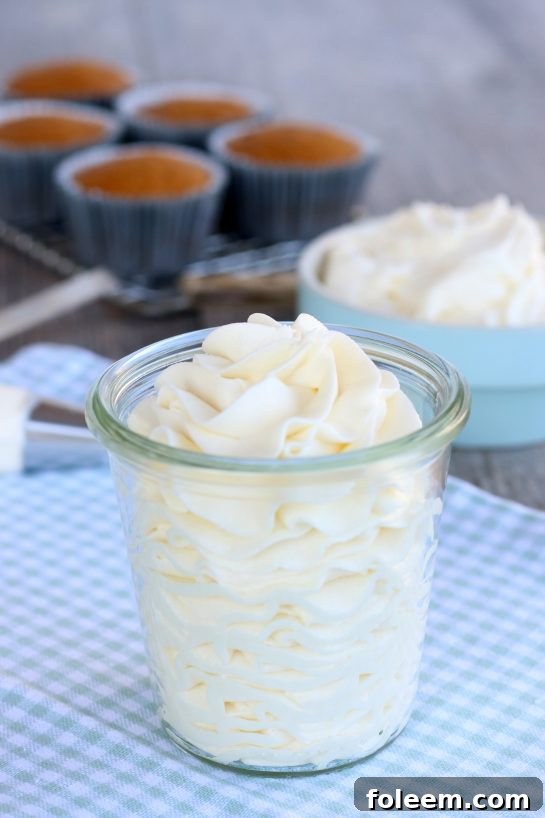 The best buttercream frosting finished and piped into a cup ready to eat or be put onto cakes, cupcakes, and breads.
