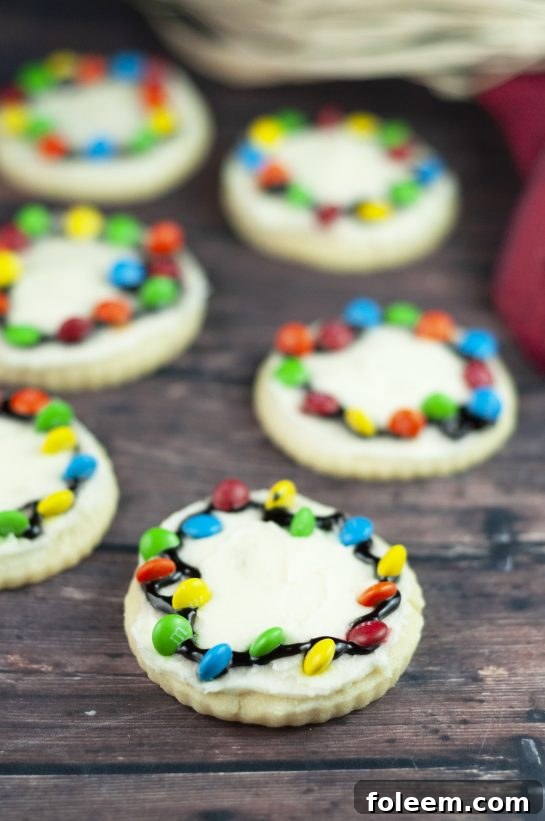 A tray of beautifully decorated Christmas Light Bulb Cookies, showcasing their simplicity and festive appeal, a perfect homemade gift idea.