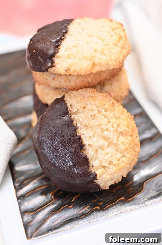 Delicious Chocolate Dipped Coconut Macaroons on a baking sheet, ready for the holidays.