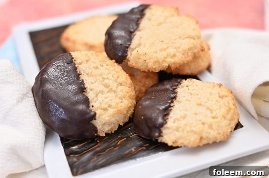 Close-up of freshly baked Easy Chocolate Dipped Coconut Macaroons, showcasing their sweet and chewy texture.