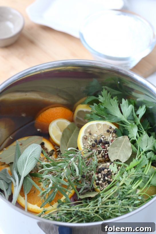 Adding fresh seasonings and aromatics to the brine mixture, essential for a flavorful turkey brine recipe.