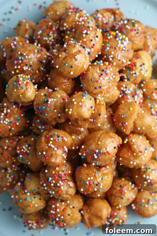 A top down shot of the finished struffoli recipe, perfectly brown and ready to be enjoyed.