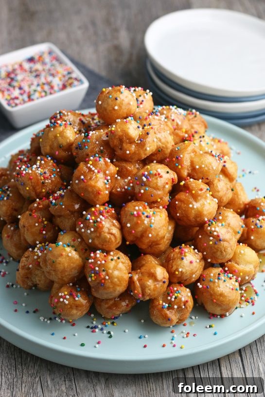 A view of the finished Italian honey balls piled up and decorated ready to be enjoyed.
