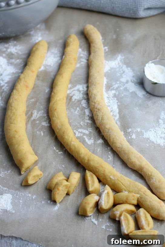 The dough is rolled out and cut into bite sized pieces which will form the struffoli dough balls. 