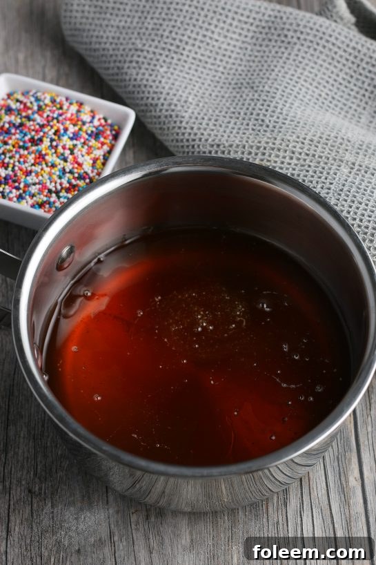 Here we see the glaze and the sprinkles for the topping are in the background, this is what gives the struffoli its sweetness.