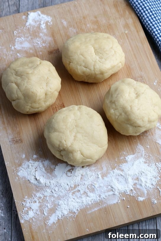 The dough is separated into four balls to make Italian fig cookies.