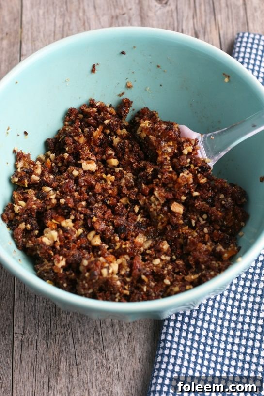 Now we have to mix together the chopped figs, nuts, and seasonings for the filling for our fig cookies.