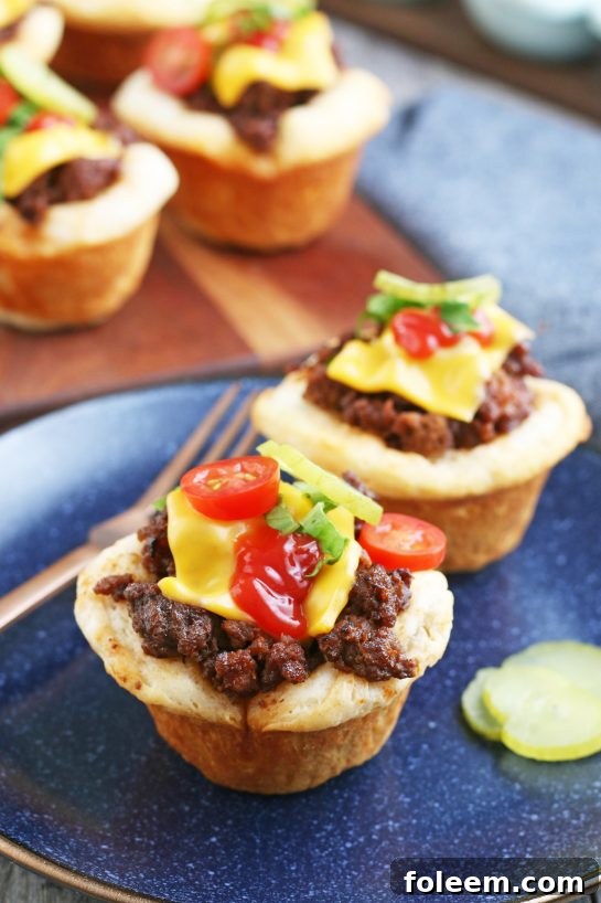 A delightful presentation of completed cheeseburger cups artfully arranged on a plate, eagerly awaiting to be savored.