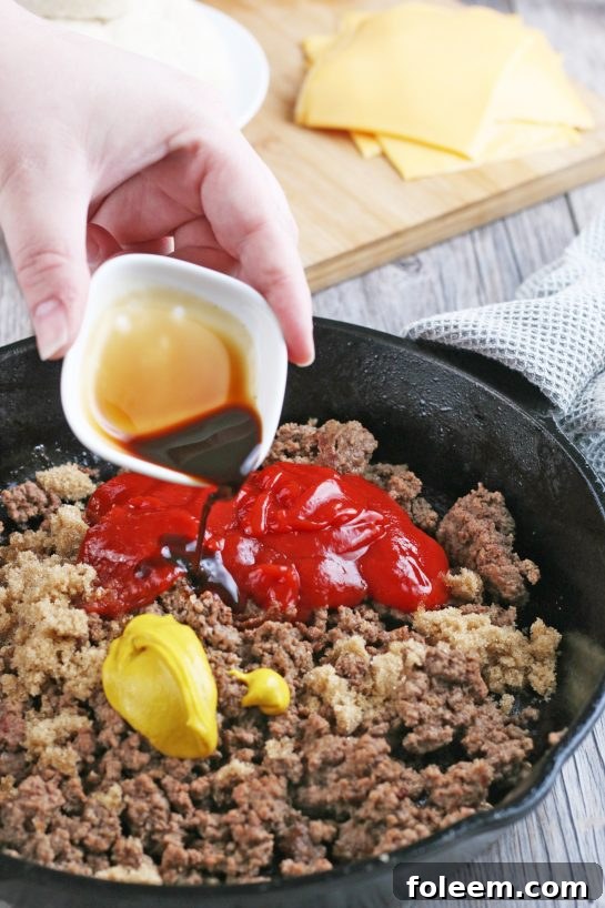 After cooking the beef, we add the seasonings, ketchup, mustard, and other ingredients to create a flavorful cheeseburger mixture.