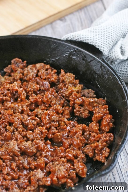 The savory meat mixture for our cheeseburger cups is now perfectly cooked and seasoned, ready to be portioned into the biscuit bases.