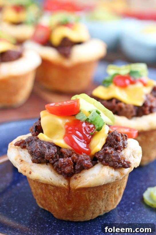 A vibrant close-up of the finished cheeseburger biscuit bites, beautifully garnished with fresh toppings and ready for enjoyment.