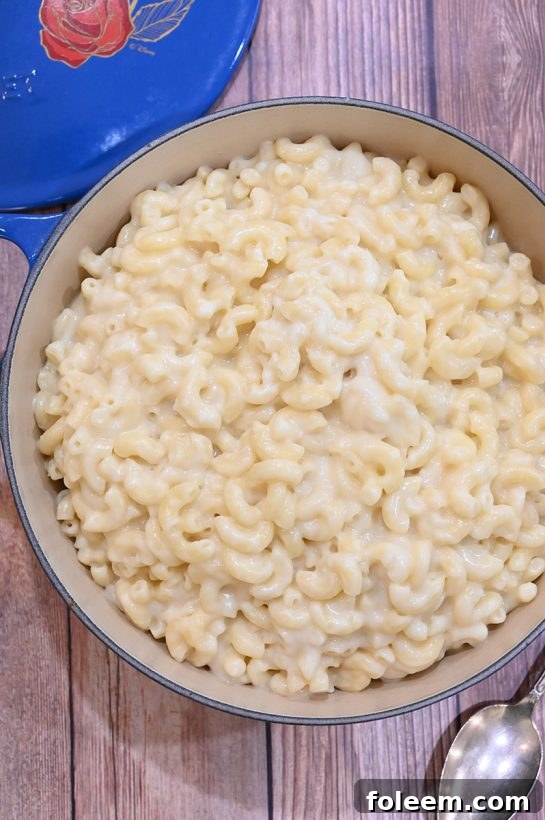 Bowl of homemade stovetop mac and cheese with a spoon, showing its creamy texture
