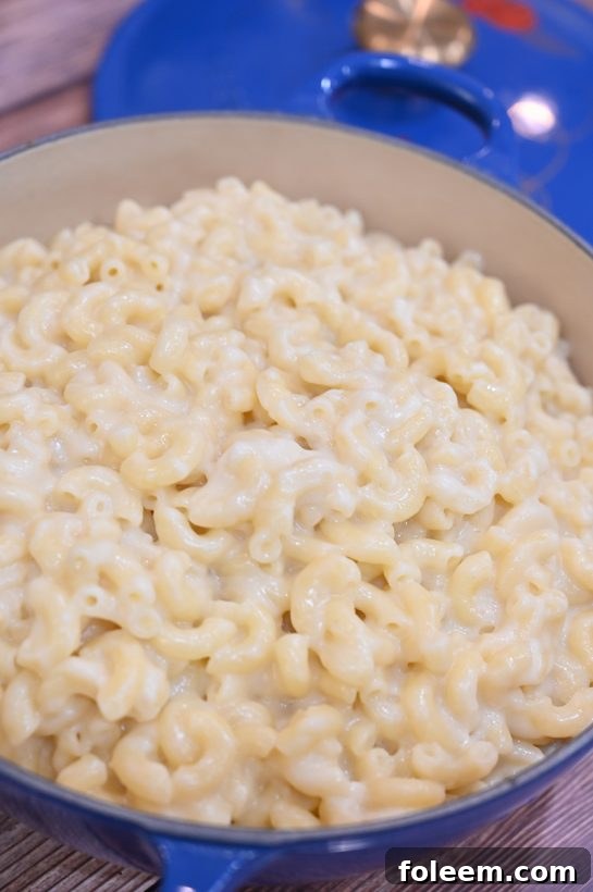 A dish of rich stovetop mac and cheese, featuring sharp white cheddar for extra flavor