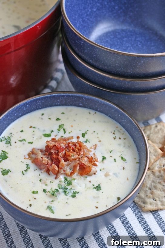 A bowl of soup with crispy bacon added on top ready to be enjoyed.