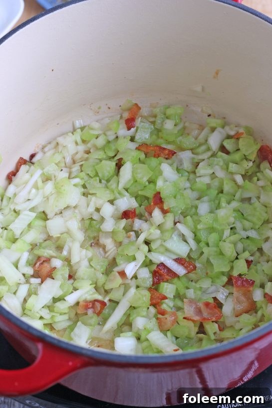 Now the vegetables, bacon, and seasonings are mixing within in pot as we make our New England clam chowder recipe.