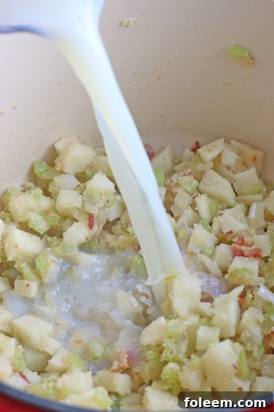 Image shows the liquid being added to make the broth of our New England clam chowder recipe.