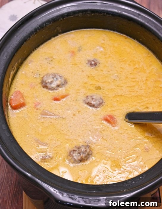 Delicious and easy Slow Cooker Cheesy Meatball Soup, perfect for a cozy family dinner