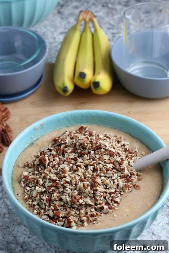 Adding the pecans for the Homemade Hummingbird Cake recipe