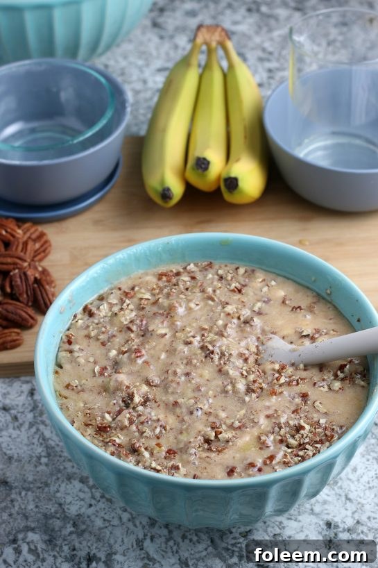 Mixing in the pecans for the Homemade Hummingbird Cake recipe