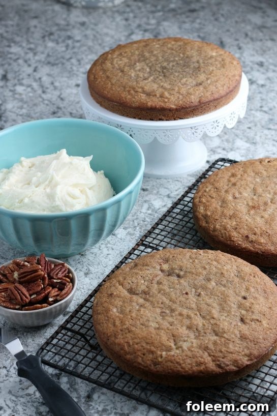 Taking the cake pans out of the oven for the Homemade Hummingbird Cake recipe