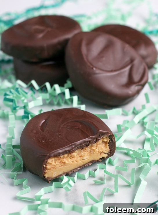 Here we see the finished homemade chocolate peanut butter eggs all laid out, some cut open, ready to be enjoyed for Easter or any occasion.