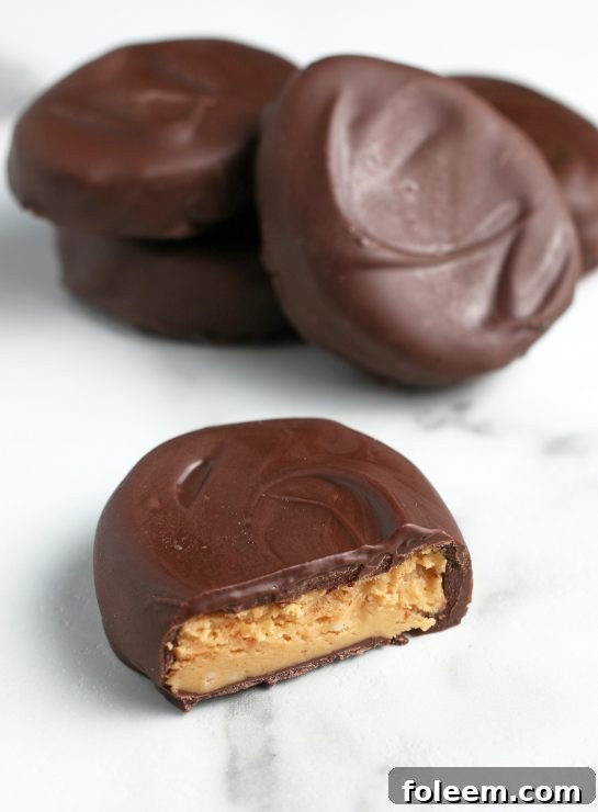 A close-up view of the finished homemade chocolate peanut butter eggs all laid out, some cut open, and ready to be enjoyed for Easter!