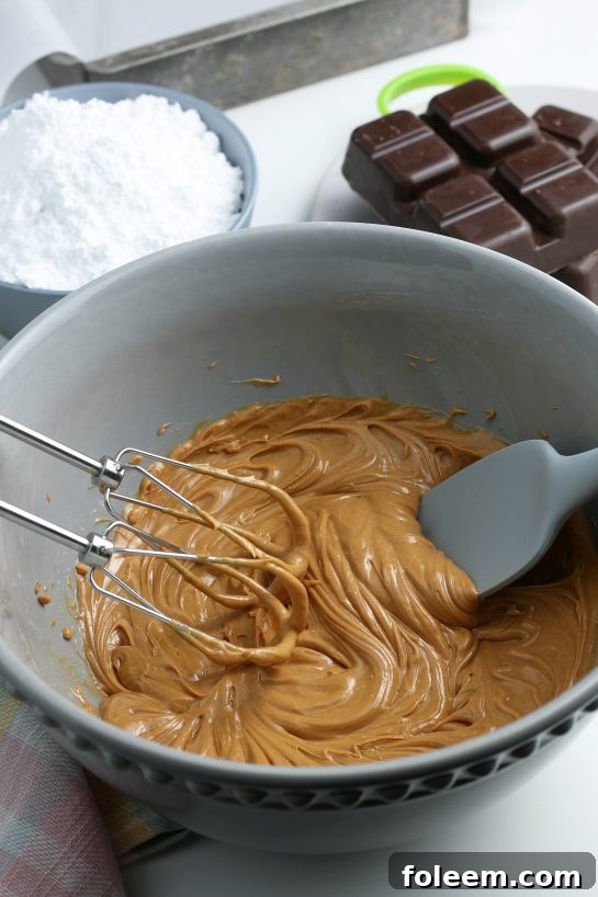 Now that the wet ingredients are smooth and creamy, we're ready to start adding in the dry ingredients for our peanut butter egg filling.