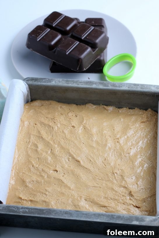 Now the peanut butter batter is pressed evenly into a pan and can be put into the freezer until firm, ready for shaping!