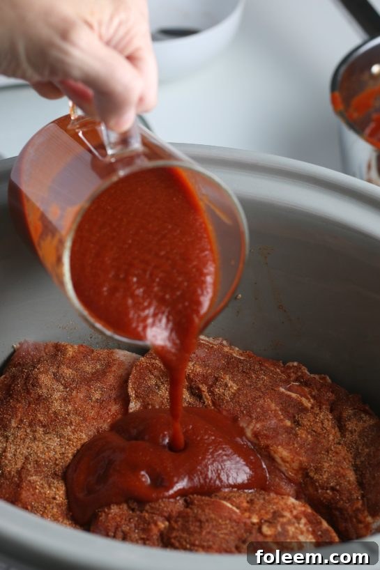 Now they're loaded into the slow cooker and we can add our sauce so that the crock pot ribs can cook!