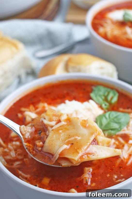 A spoonful of the delicious lasagna soup ready to be enjoyed.