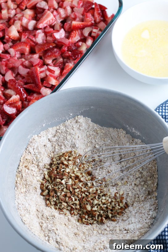 Adding the chopped nuts for Strawberry & Rhubarb crisp recipe