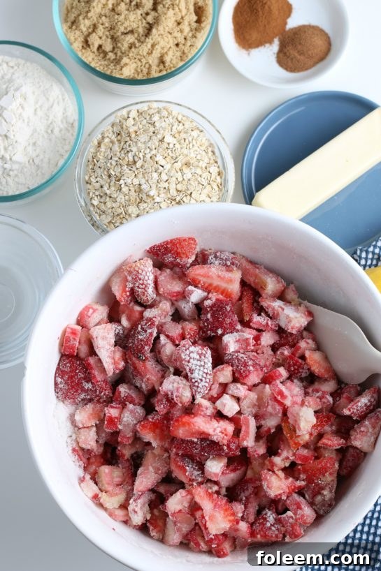 Mixing the dry ingredients with wet ingredients for Strawberry & Rhubarb crisp recipe