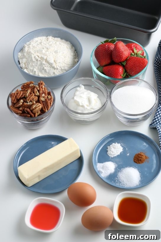 All the fresh and pantry ingredients for our homemade strawberry bread recipe, neatly laid out on a clean surface, ready for mixing and baking.