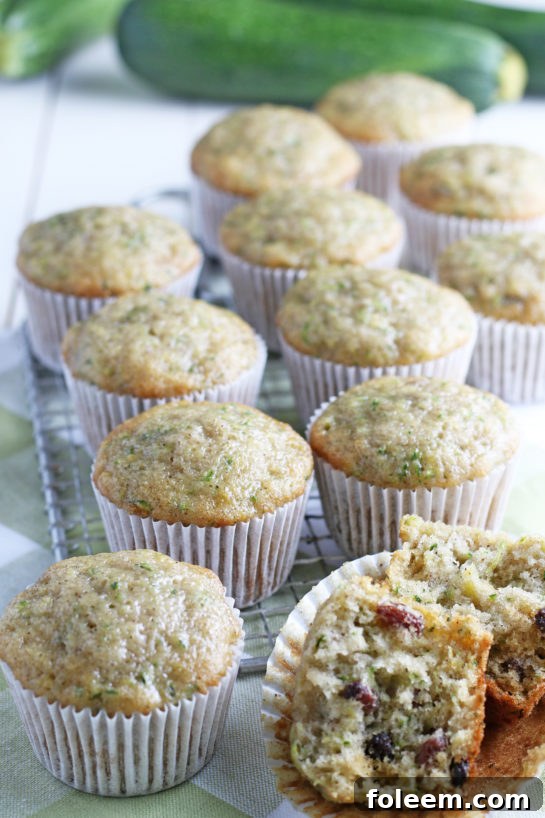 Super soft Zucchini Muffins, perfectly baked with a hint of cinnamon spice, showcasing their tender texture and the richness of fresh zucchini. Ideal for breakfast or a sweet treat.