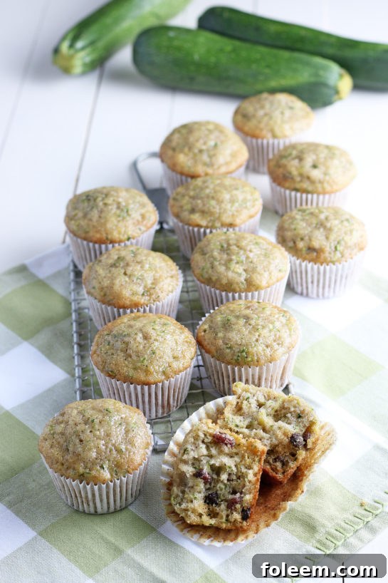 A batch of super soft Zucchini Muffins, perfectly baked with a hint of cinnamon spice, displayed ready for breakfast or brunch. Showcasing their tender crumb and delicious appeal.