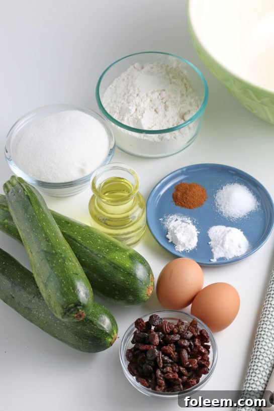 All the essential ingredients for making delicious Zucchini Muffins laid out on a kitchen counter, including flour, sugar, eggs, oil, shredded zucchini, and cinnamon.