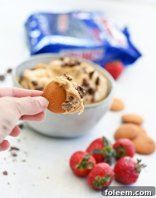 Easy Peanut Butter Crunch® Bar Dip is a sweet dunkable dessert dip recipe that's perfect for parties and made in less than 10 minutes. Slice up an apple and dig in!
