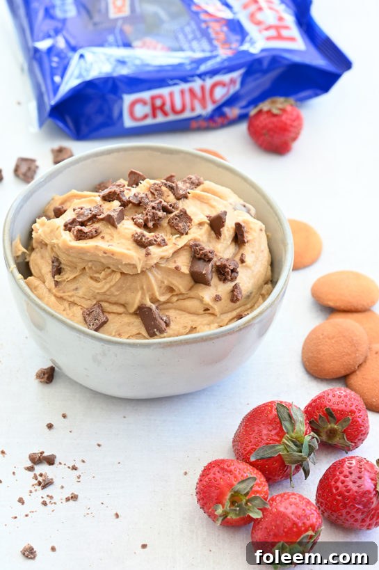 Indulgent Peanut Butter Crunch® Bar Dip is a sweet dunk-worthy dessert dip recipe that's perfect for parties and made in less than 10 minutes. Slice up an apple and dig in!