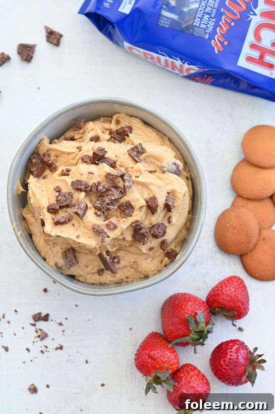 Indulgent Peanut Butter Crunch® Bar Dip is a sweet dunkable dessert dip recipe that's perfect for parties or game day and made in just 10 minutes. Slice up an apple and dig in!