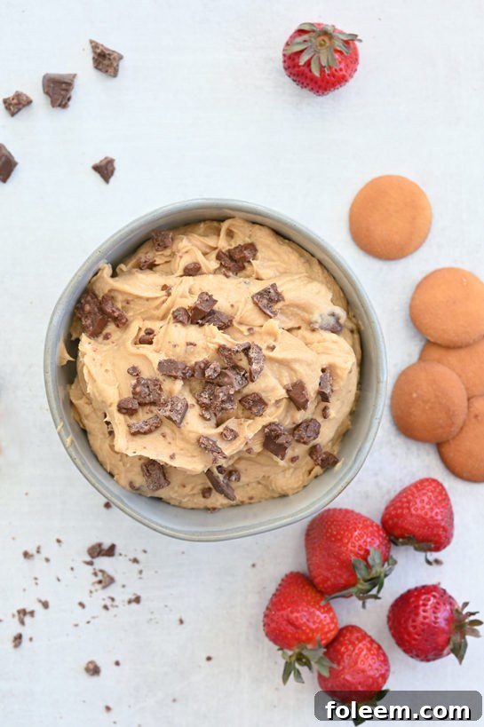 Candy Peanut Butter Crunch® Bar Dip is a sweet dunkable dessert dip recipe that's perfect for parties and made in less than 10 minutes. Slice up an apple and dig in!