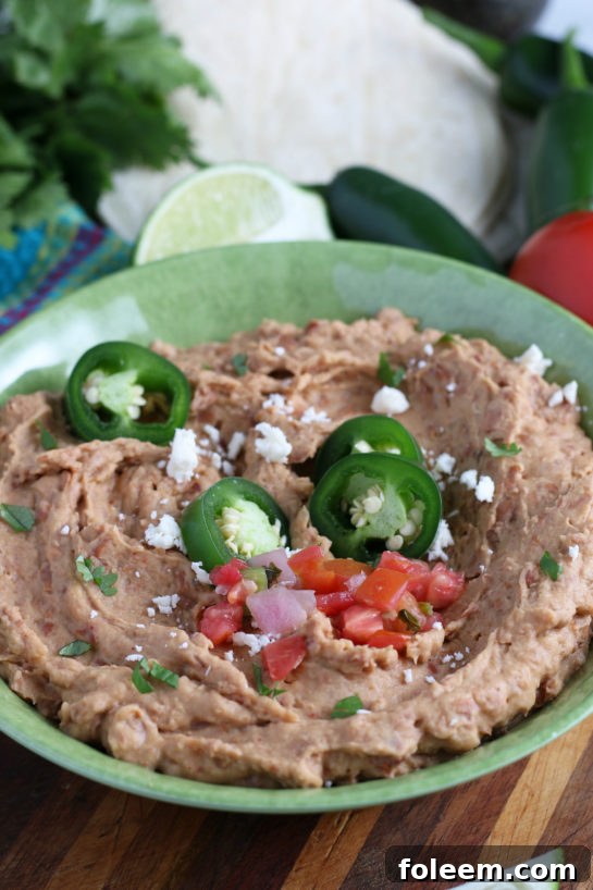 A close-up of a serving of homemade refried beans, highlighting their restaurant-quality appearance and texture.