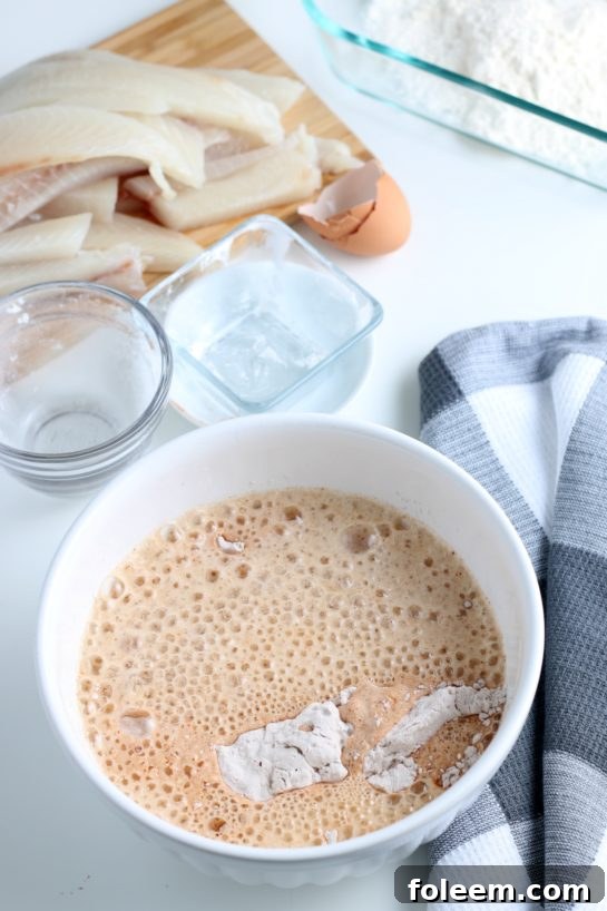 The process of combining wet and dry ingredients, forming a cohesive beer batter