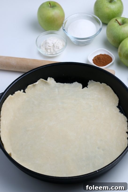 Placing the pie crust dough in the pan for the apple crostata recipe