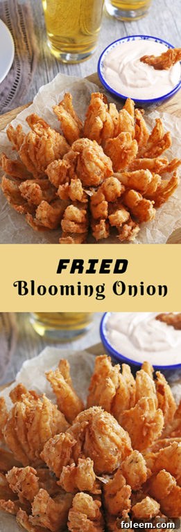 A stunning shot of a golden, crispy deep-fried blooming onion, ready to be pulled apart and enjoyed, with its dipping sauce visible.