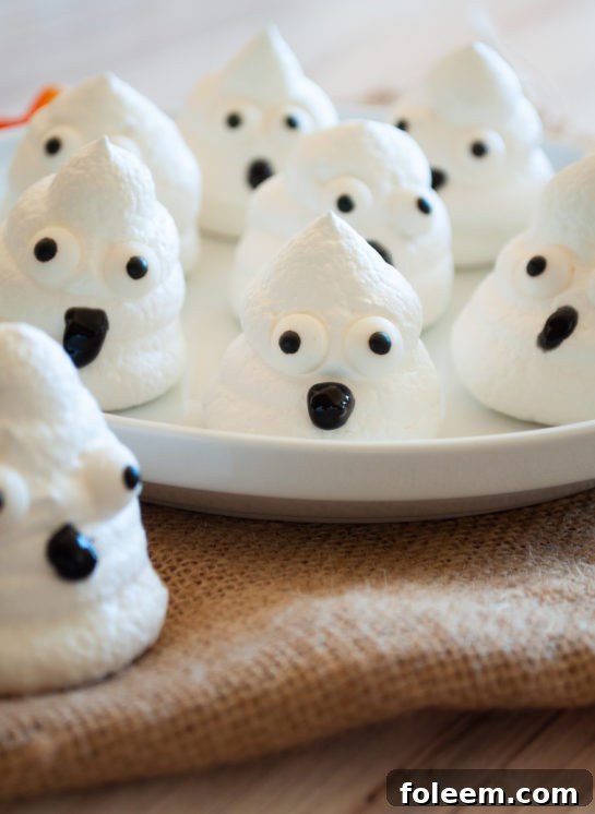 A stack of simple Halloween Boo Meringues, artfully arranged and showcasing their whimsical charm, perfect for eating.