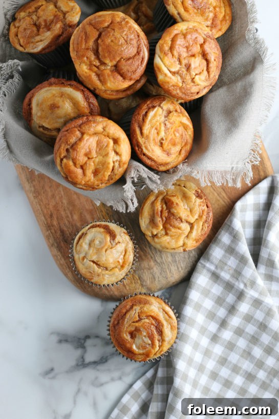 Freshly baked Pumpkin Cream Cheese Swirl Muffins cooling on a rack, ready to be enjoyed for a fall or Thanksgiving dessert.
